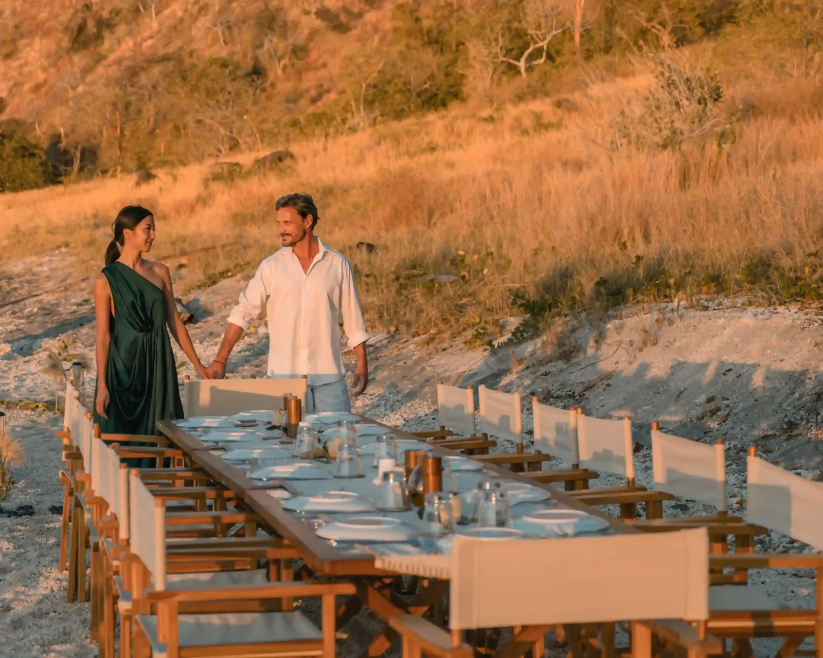 A couple at a table set on the beach