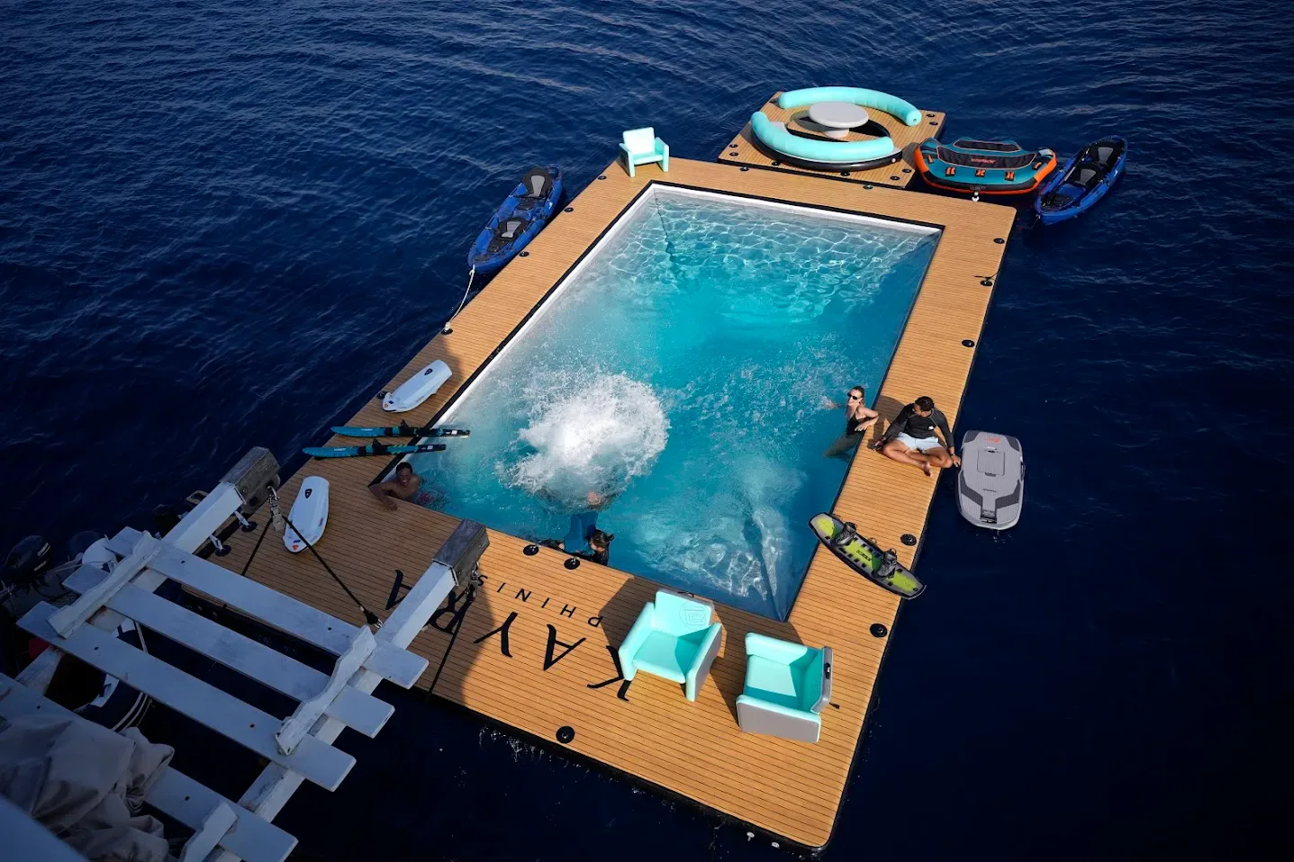 A floating pool platform beside a phinisi