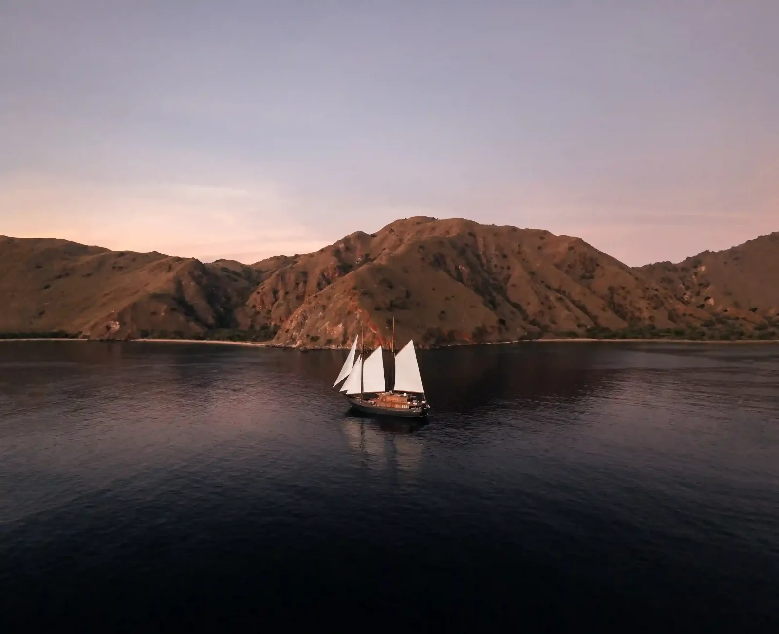 A phinisi at anchor at dusk