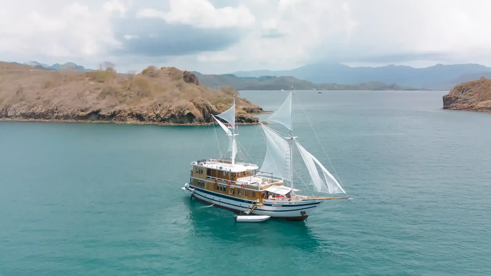 A phinisi anchored in a sheltered bay