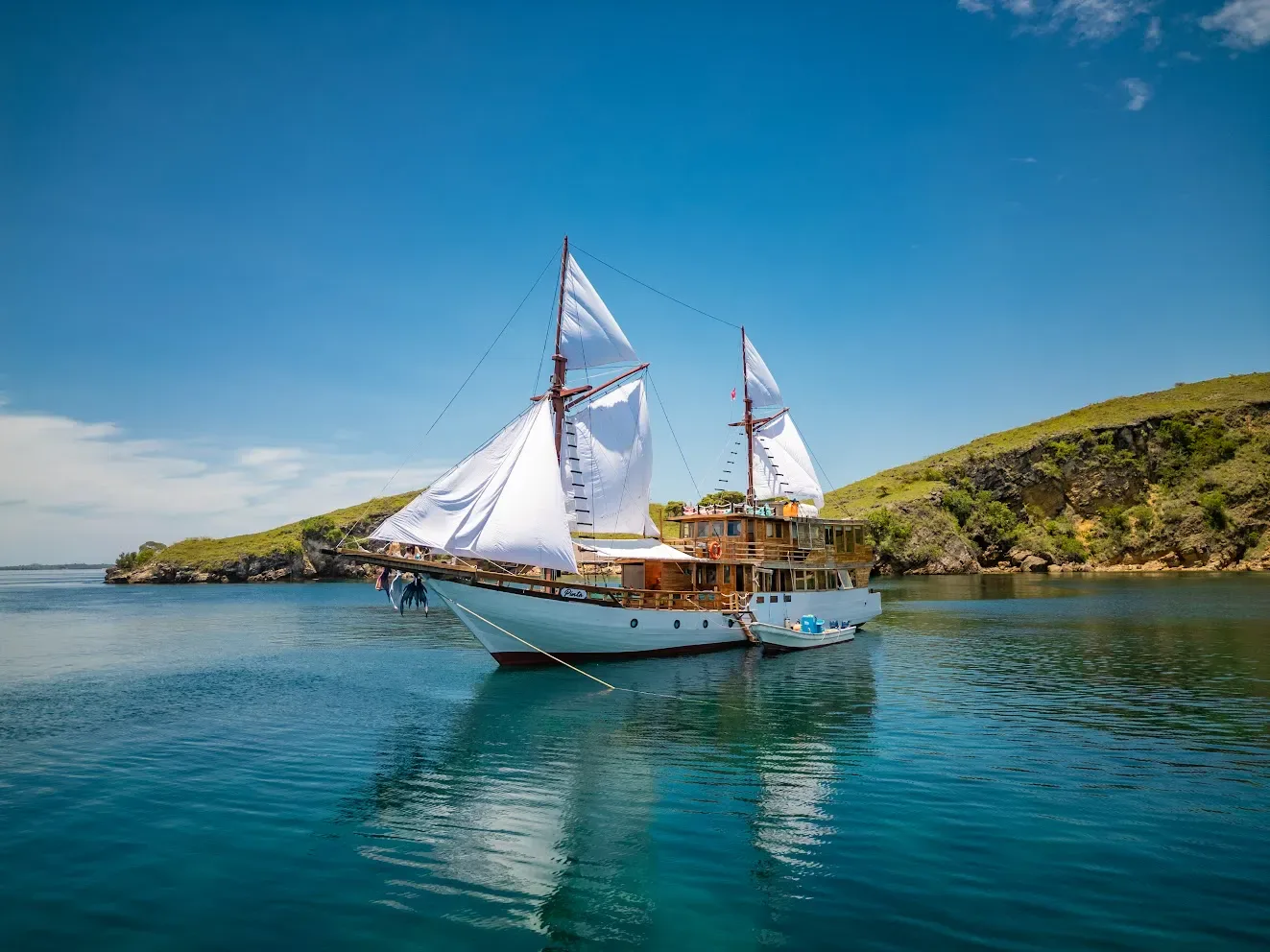 A phinisi anchored off a small island