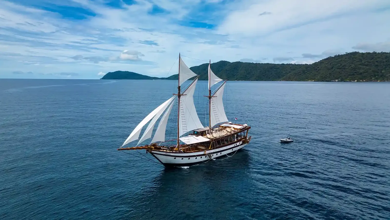 A phinisi under sail in open water